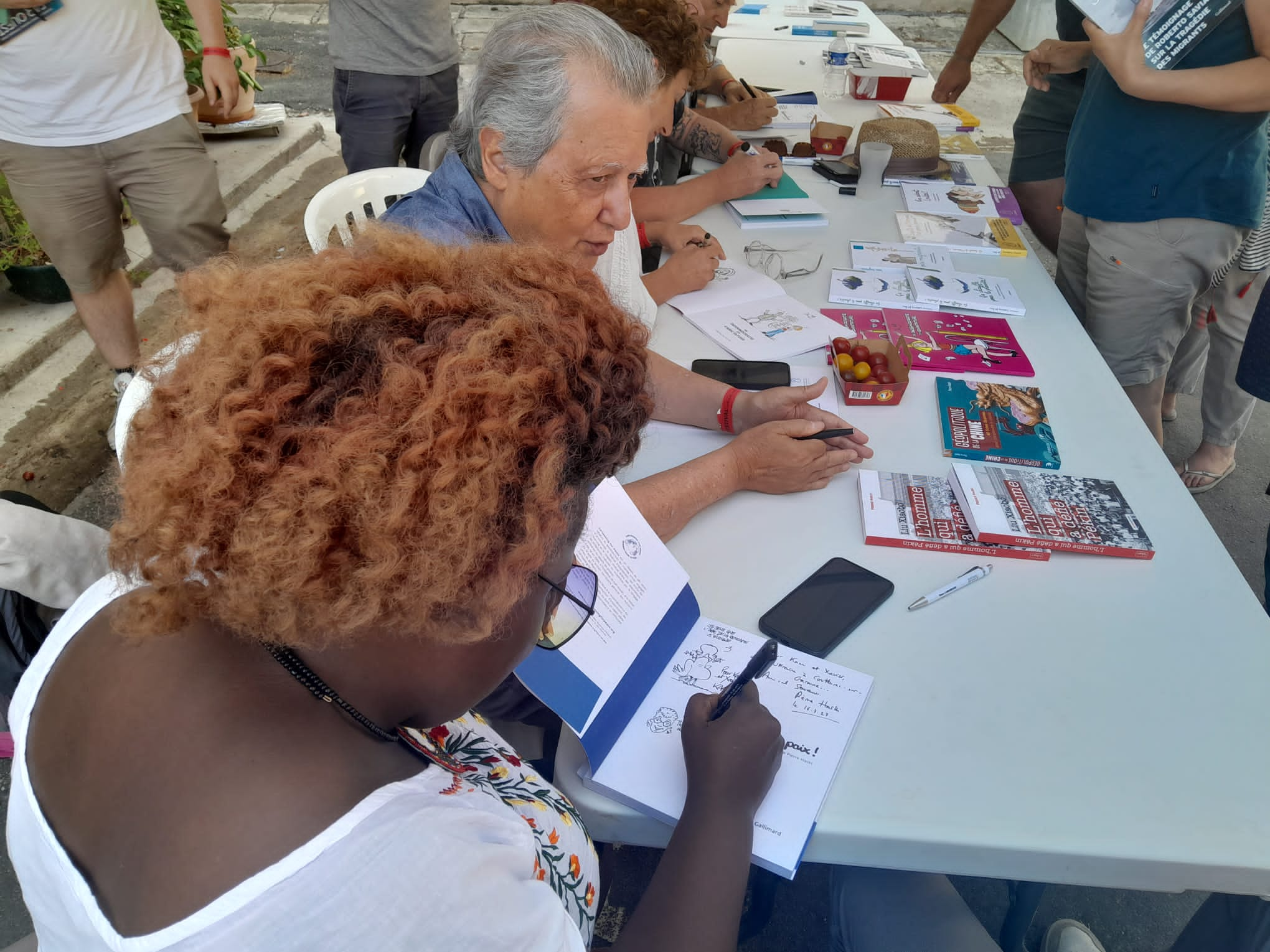 Séance de dédicaces avec les dessinateurs et Pierre Haski autour du livre « Fichez-nous la paix ! » – Celeste (Kenya) et Pierre Haski